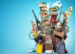 A colorful stack of luggage and travel essentials with iconic landmarks in the background, symbolizing a family preparing for an airport transfer to Alicante.